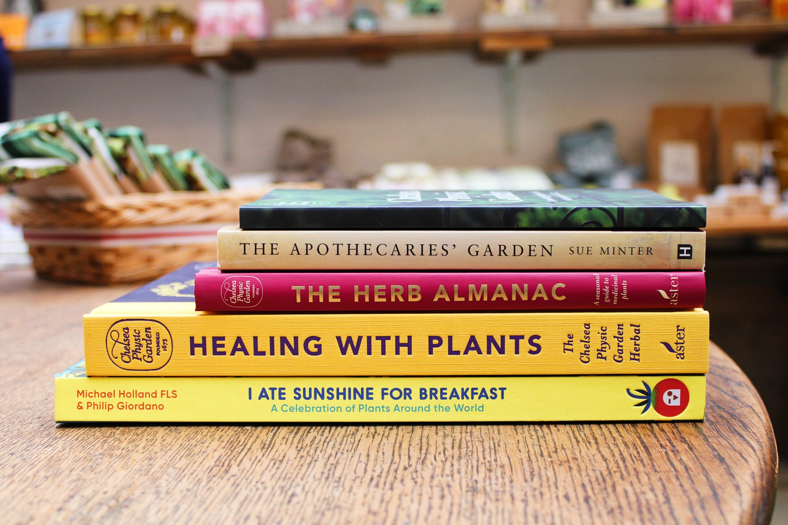 A pile of colourful books about Chelsea Physic Garden and its history.