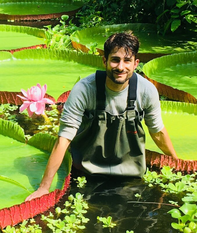 Chris Thorogood with giant green waterlilies at a lake